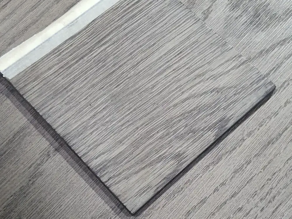 Farbmuster auf grauem Eichenfurnier zum Abgleich.