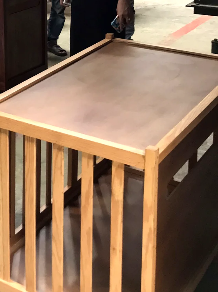 Dog resting on a wooden pet sofa